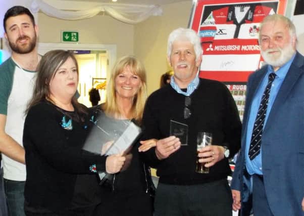 The Beeney family receive their award at Hastings & Bexhill's presentation night alongside club president Roy Wake. Picture courtesy Peter Knight