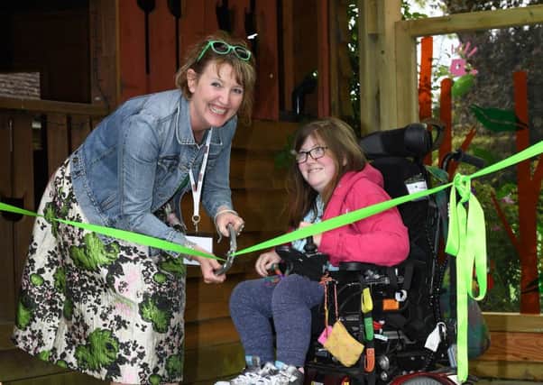 Ann-Marie Powell cutting the ribbon at a Greenfingers garden at an Oxford children's hospice