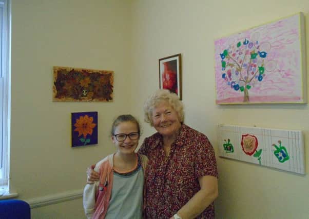 Betsie Field and her nan Jean in front of their exhibits