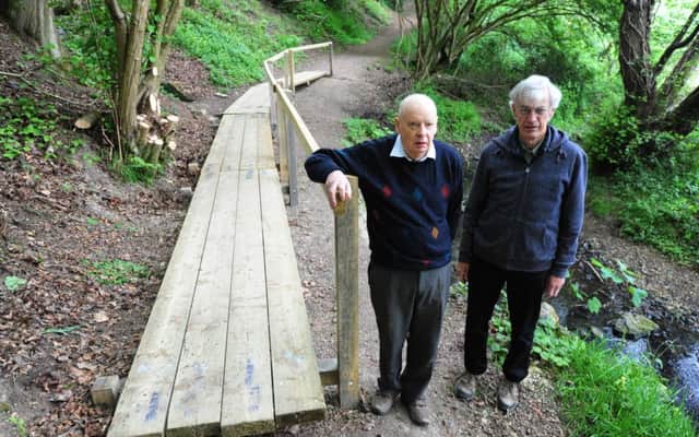 Peter Jerrome and Gordon Stevenson on the bridge that has recently been put up in front of the spring.ks170886-2