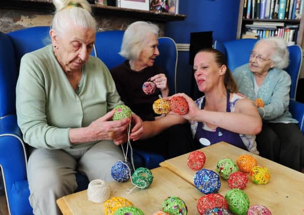 Activities co-ordinator Wendy Bray works with Lavender Lodge residents on a craft activity. Picture: Kate Shemilt ks170942-2