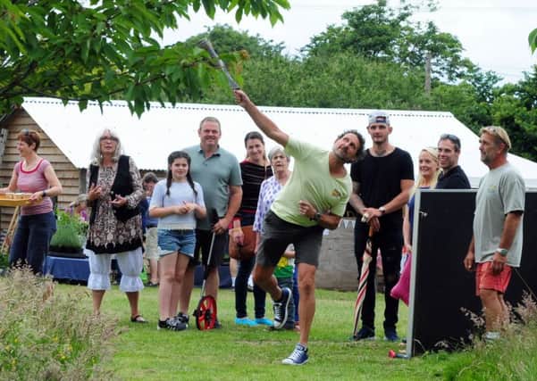 Jon Davis tries his hand at welly  throwing at the inaugural Earnley Fete. Picture: Kate Shemilt ks16000776-1