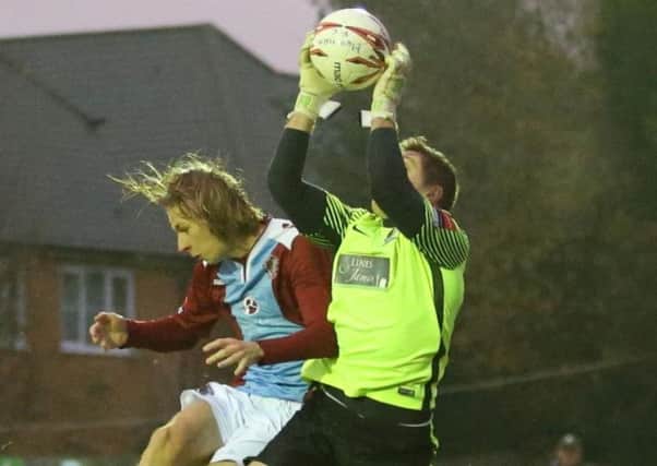 Josh Pelling claims an aerial ball for Horsham against Hastings United last season. Picture courtesy Scott White