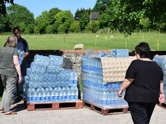 Water bottles were handed out to residents. Photo by Dan Jessup