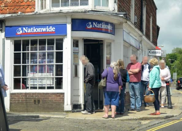 Customers queue outside the Battle branch of Nationwide following this morning's raid. SUS-170506-143138001