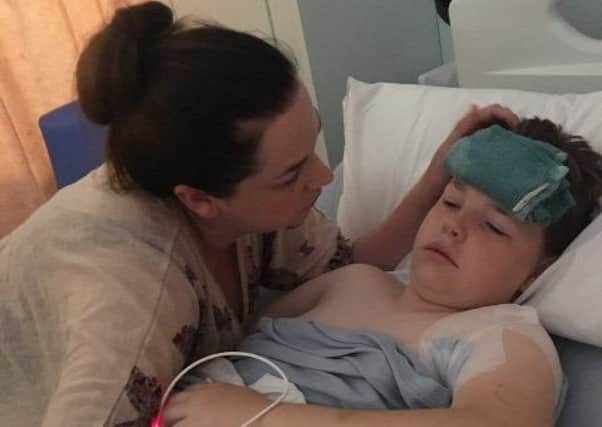 Ashton, 11, with his mum Jodie, 28, in hospital after the accident