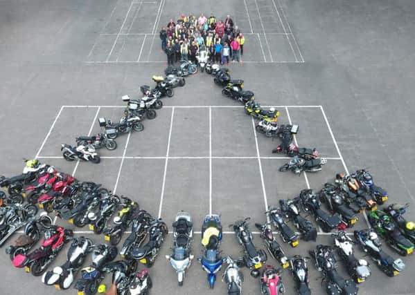The team with their motorcycles in the shape of the Square and Compasses