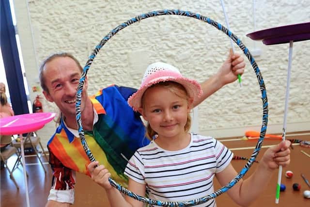 Childrens Extravaganza seven-year-old Harriot Wingfield with Matt Dumbleton from Circus Seen. Picture: Stephen Goodger
