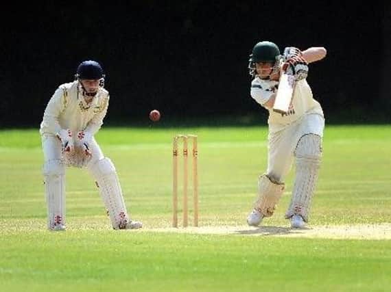 Three Bridges' Joe Walker, left, keeps wicket on Saturday as Ifield's Paul Clifford bats..
Picture by Steve Robards.