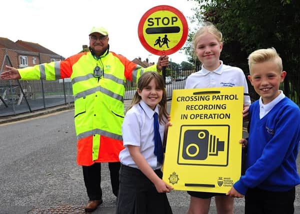 Patrol officer David Holland with pupils Abbie Wise, Ciara Watts and Arthur Jameson
