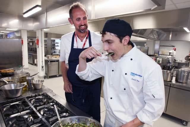 Chef Cameron Matthews and student Thomas Daniels, tasting the food. Photo by Derek Martin. DM17527510a.jpg