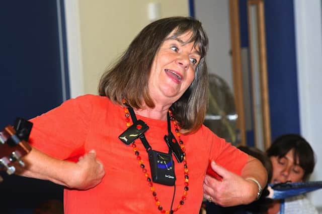 Julia Donaldson demonstrates the actions to go with the song