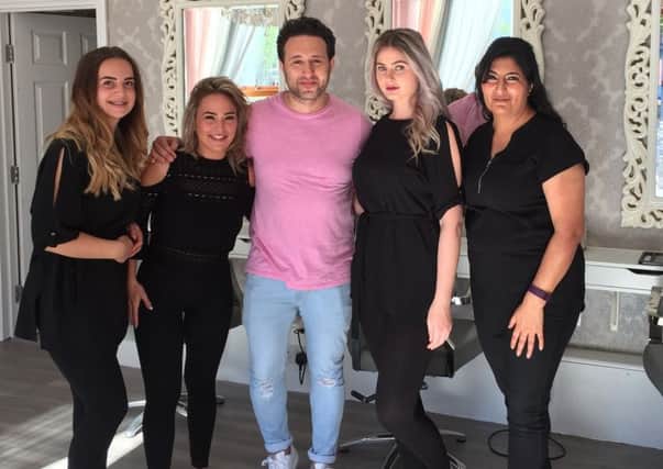 Anthony Costa from the band Blue with staff from Amara Hair and Beauty Lounge in Crawley SUS-170614-170352001