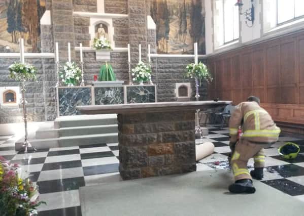 Firefighters at St John's Church, Horsham, after a fire at the altar SUS-170615-142621001