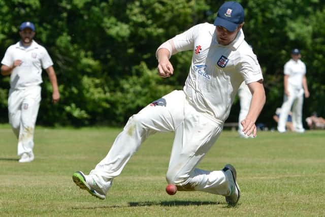 A Bexhill fielder slides to stop the ball against Ansty. Picture courtesy Peter Cripps.