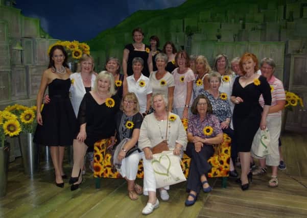 Cast members of THE GIRLS with the ladies of the Pett WI. Sophie-Louise Dann is pictured in black far right