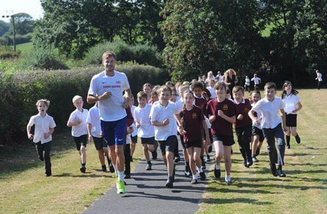The 'Daily Mile' at Park Mead Primary School, Upper Dicker, being led by Olympic athlete Seb Rodger