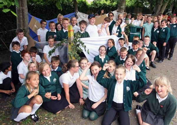 Year-five pupils with one of the shelters they made on Build a Den Day at White Meadows Primary Academy Photo by Derek Martin DM17628991a