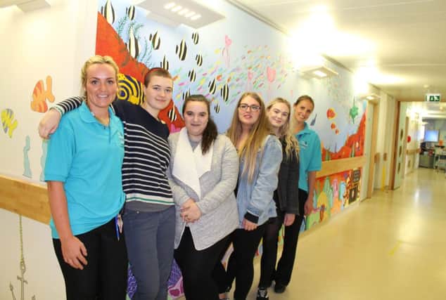 From left: Amy Farmer, of the Alex, Li Lord, Georgia Burgess, Paige MacRae, Iona Halfpenny and Alice Pashley, of the Alex, with the mural