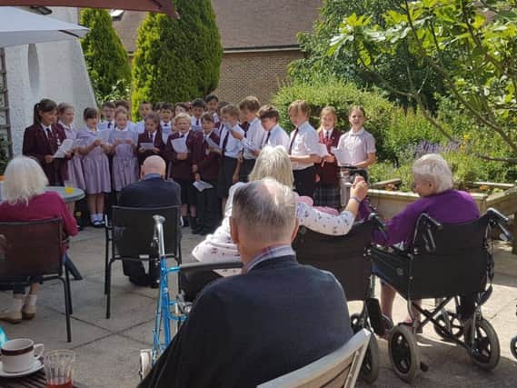 Students from Battle Abbey Prep School sang to residents at the home