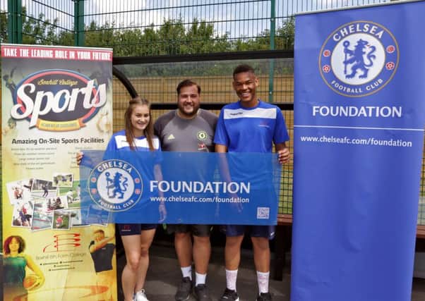 Bexhill 6th Form College football academy players Casey Sands and Tyrone Lukun either side of Nick Brown, Chelsea's south east senior sports development officer.
