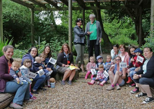 Forest School Tots presents a Â£500 donation to Hotham Park Heritage Trust chairman Rosemary Warren