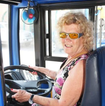 Jan Penn tries out the driver's seat on the bus DM17629820a