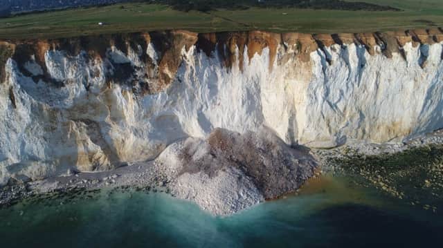 The first major cliff fall last week as hundreds of tons of chalk collapsed onto the beach below. Photo by Eddie Mitchell.