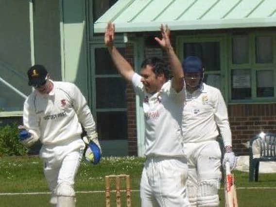 Horsham's Michael Munday celebrates a wicket during his spell of 8-38 against Bexhill on Saturday. 
Picture by Simon Newstead