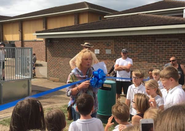 Anna Worthington-Leese cuts the ribbon to formally open the playground