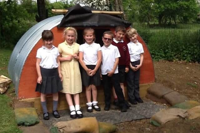 Fishbourne CE Primary School pupils outside the Anderson shelter