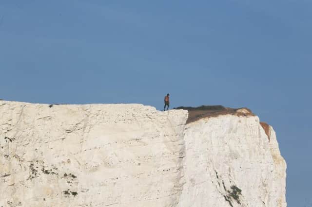 A person seen on the edge of the cliffs after the first fall, photo by Eddie Mitchell SUS-170623-111905001