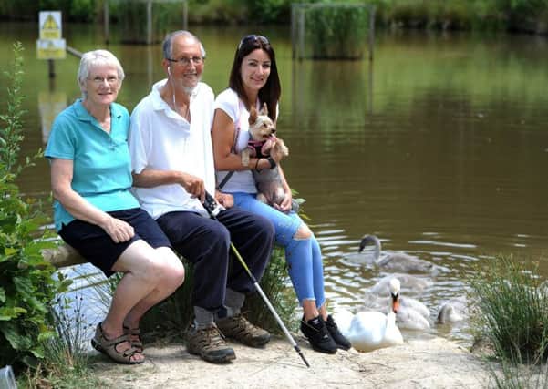Clare Hill and her dog (far right), with Chris Cowell and her friend Bob who are concerned about dog attacks on swans in Tilgate Park. Pic Steve Robards SR1714949 SUS-170626-092349001