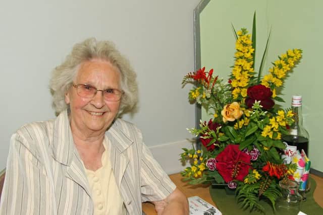 Sylvia Hesling with her flower arrangement, which won best floral art exhibit