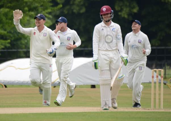 Bexhill wicketkeeper Malcolm Johnson leads the celebrations after the fall of an early Cuckfield wicket. Picture courtesy Andy Hodder