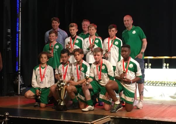 Chichester City youth under-12s pick up their medals from Darren Anderton