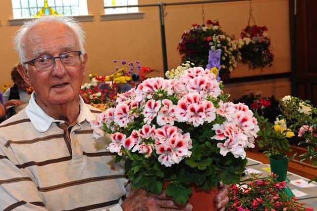 Ted Banks, winner of the most prize money, with his pelargoniums. Pictures: Stephen Goodger