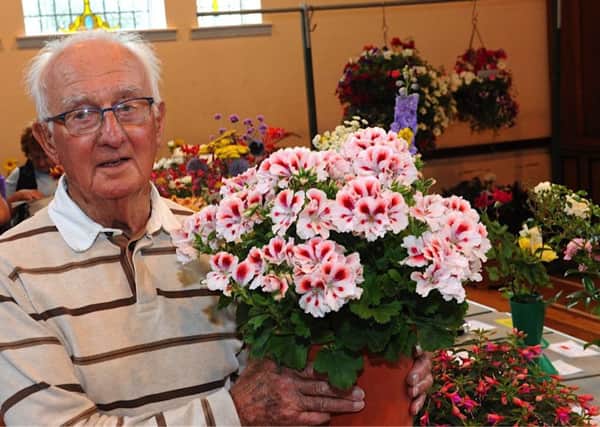 Ted Banks, winner of the most prize money, with his pelargoniums. Pictures: Stephen Goodger