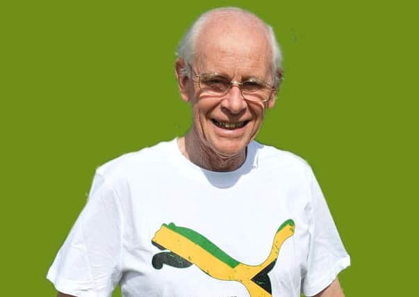 Bill Kent, secretary of reMEmber, wearing the t-shirt presented to the charity by sprinter Usain Bolt