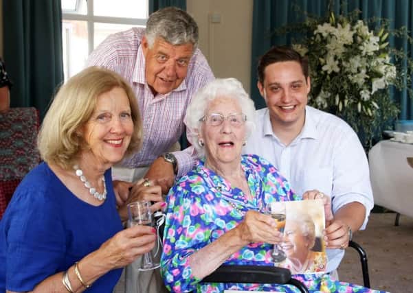 Centenarian Sheila Dunlop with her family, from left, Jane Monro, Andrew Dunlop and Archie Dunlop at Donnington House Care Home in Chichester. Picture: Derek Martin DM17630913a
