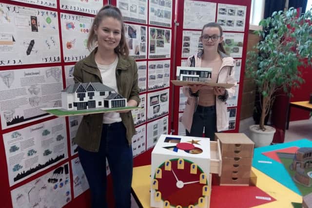A-level graphics students Lucy Cook and Jessie Brown  with their work