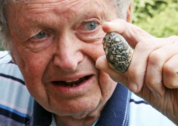 Colin with his ancient fossil he found near Worthing Pier. Pictures: Derek Martin