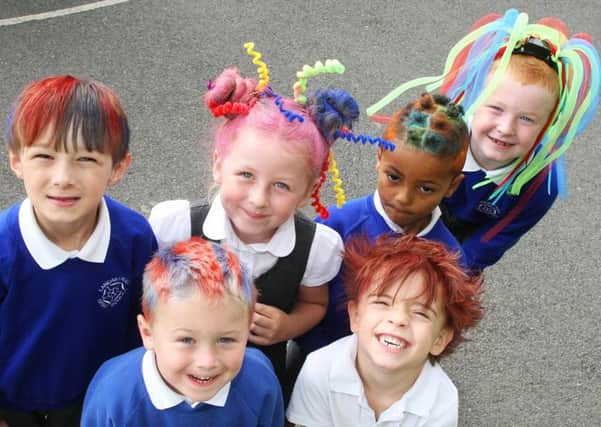 Spencer and Clare Senior with their children Emilija and George at Lancastrian Infant School for crazy hair day. Picture: Derek Martin DM17631668a