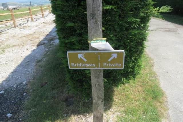 The Open Spaces Society says this sign on the bridleway past the old Lewes racecourse incorrectly diverts walkers from the public path SUS-170629-104409001