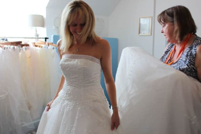 A bride-to-be trying on a dress at the shop. Picture: St Catherine's Hospice