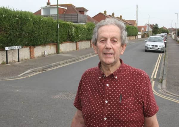 Bracklesham resident Anthony Goldsmith is angry with the parish council for refusing to object against plans to demolish a house (seen in the background) at the corner of Kimbridge Road and West Bracklesham Drive. Photo by Derek Martin