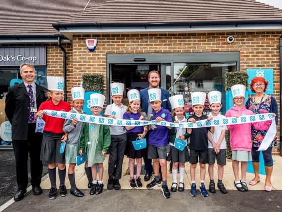 Children from Mile Oak School  help cut the ribbon at the new Portslade Co-op store