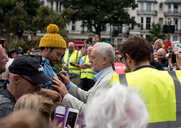Jeremy Corbyn signing a supporter's bare chest. All pictures by jessfitzhughphotography