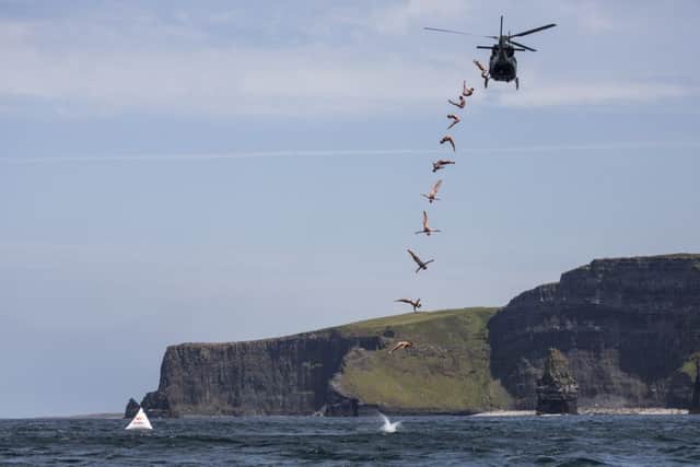 Blake Aldridge of the UK dives out of a helicopter from 25 meters at the iconic Cliffs of Moher, Ireland on June 20, 2017. // Romina Amato/Red Bull Content Pool // P-20170621-00048 // Usage for editorial use only // Please go to www.redbullcontentpool.com for further information. //