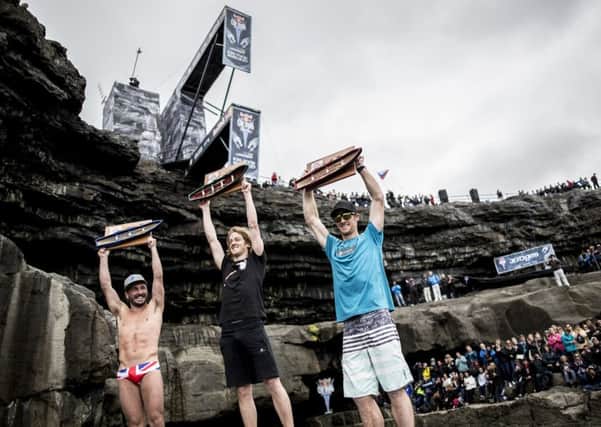 Second placed Blake Aldridge (L), winner Gary Hunt (C) of the UK, and third placed Andy Jones of the USA celebrate on the podium during the first stop of the Red Bull Cliff Diving World Series at the Serpent`s Lair, Inis Mor, Ireland on June 24, 2017. // Dean Treml/Red Bull Content Pool // P-20170624-00577 // Usage for editorial use only // Please go to www.redbullcontentpool.com for further information. //